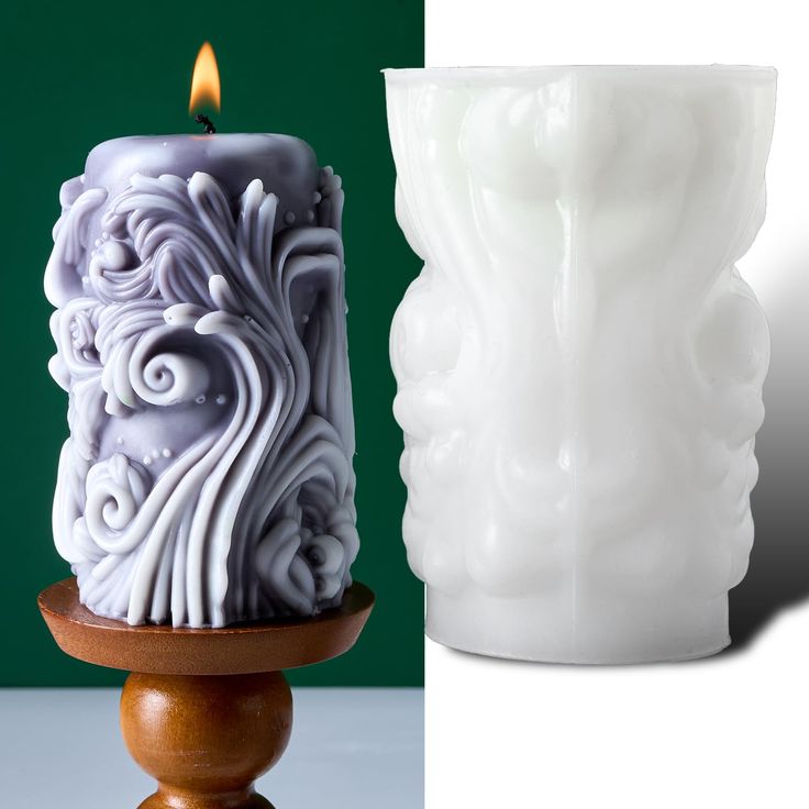 a white candle sitting on top of a wooden stand