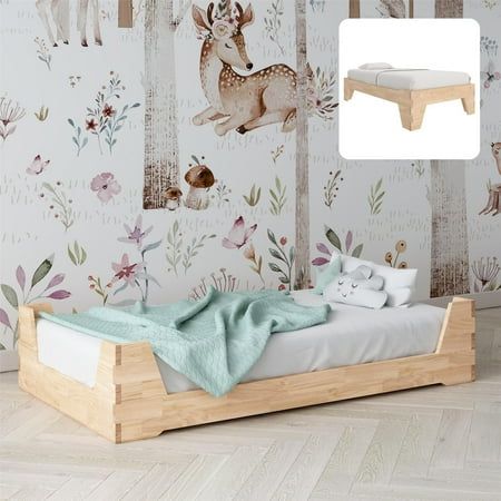 a child's bed in front of a wall with deer and flowers on it