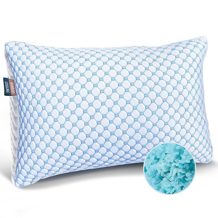 a blue pillow with white circles on it and a round button in the middle that says,