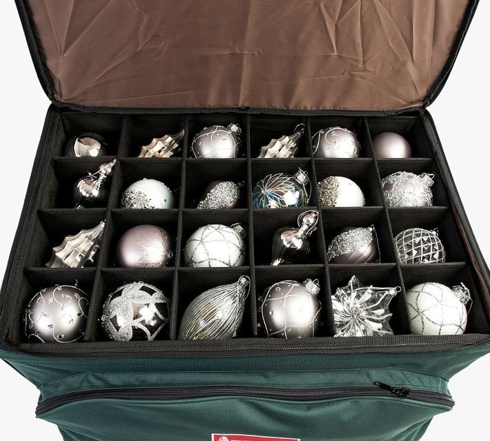 an open suitcase filled with assorted silver and white christmas ornaments in it's compartments