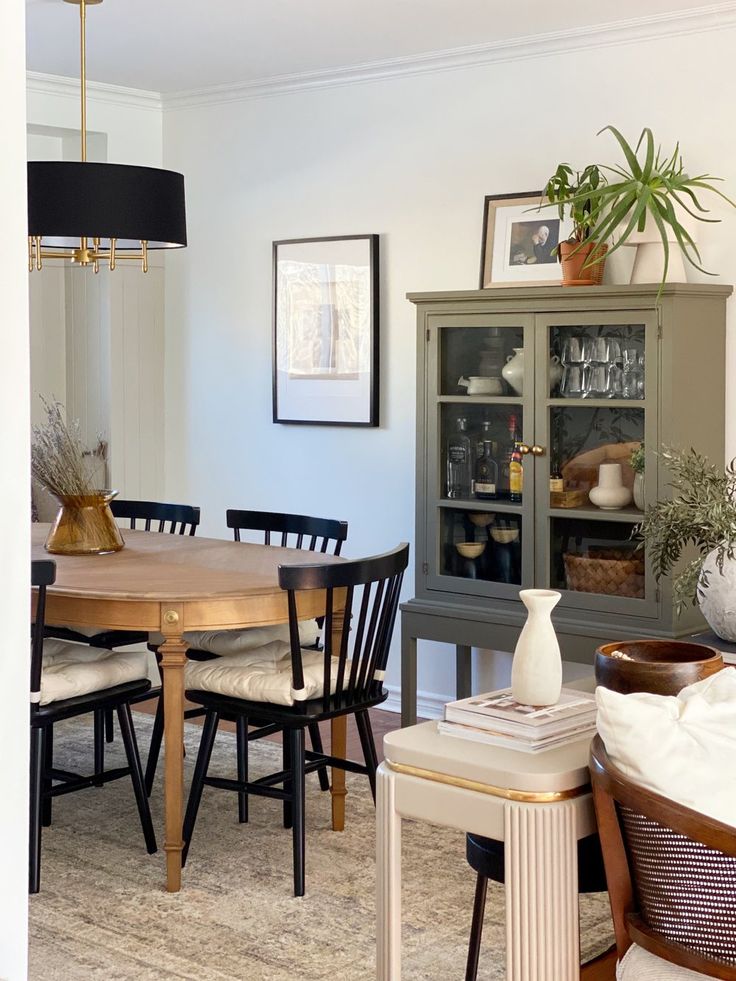 the dining room table is surrounded by chairs and other furniture in front of a china cabinet