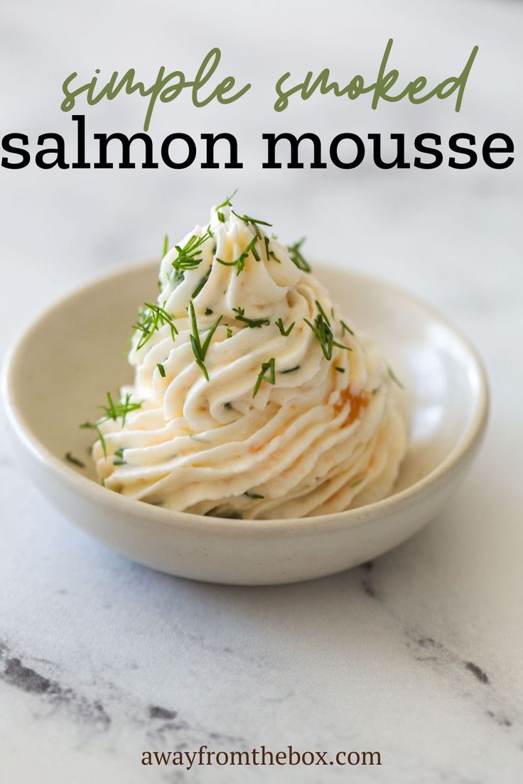 a white bowl filled with whipped cream on top of a marble counter next to the words simple smoked salmon mousse