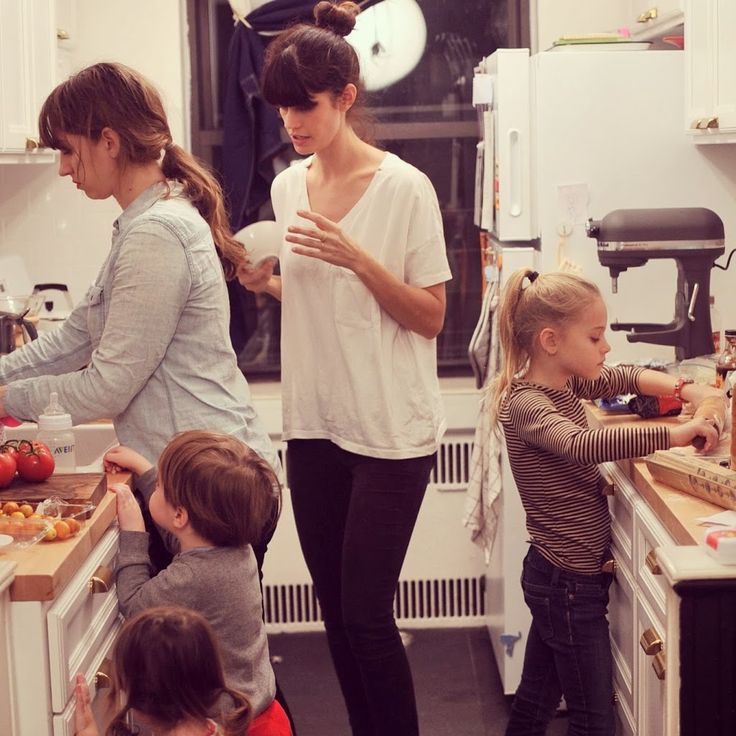 a group of people in a kitchen preparing food