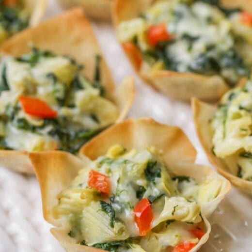 small cups filled with food sitting on top of a white plate