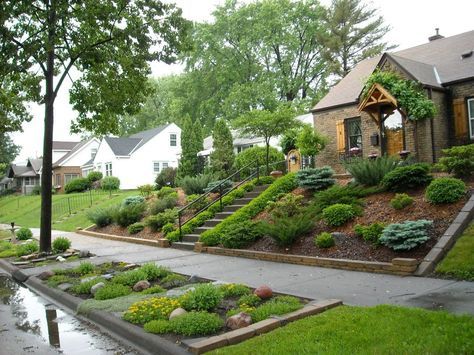 a house with lots of landscaping in front of it