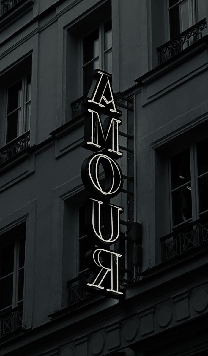 a black and white photo of the marquee for amouir in paris