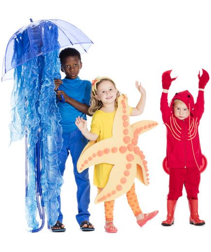 three children in costumes standing next to each other with an umbrella and starfish costume on