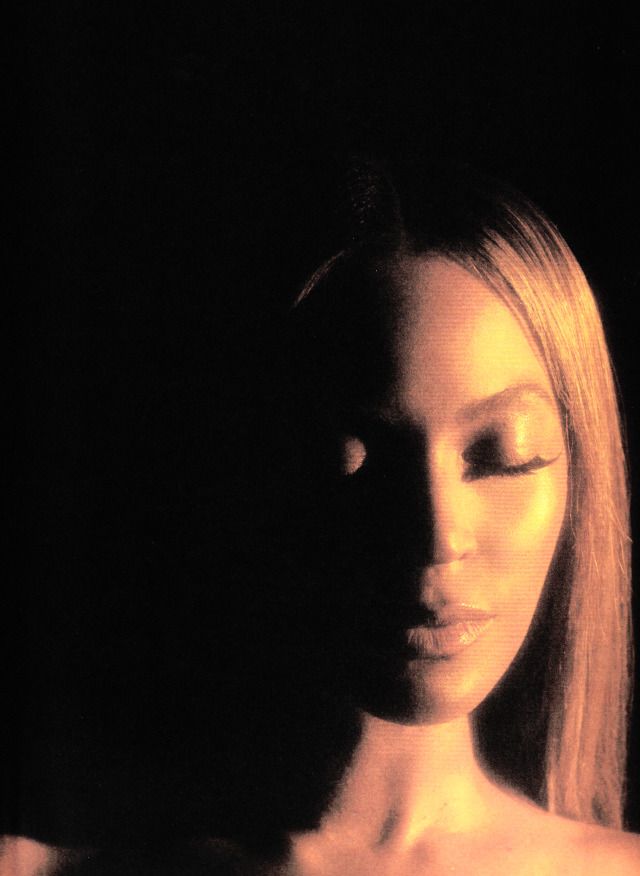 a woman with her eyes closed in the dark