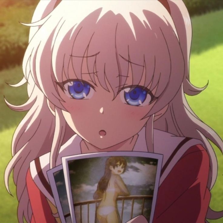 an anime character holding up a photo with blue eyes