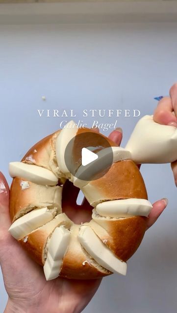 a person holding a doughnut that has been sliced into pieces and is being held by another hand