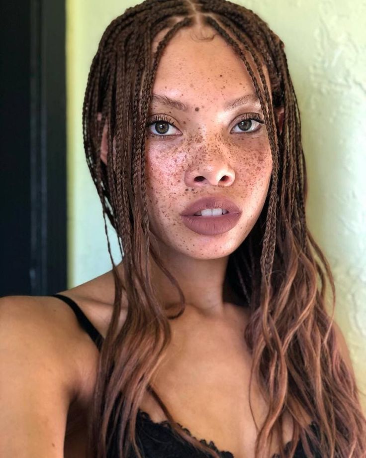 a woman with freckled hair is posing for the camera