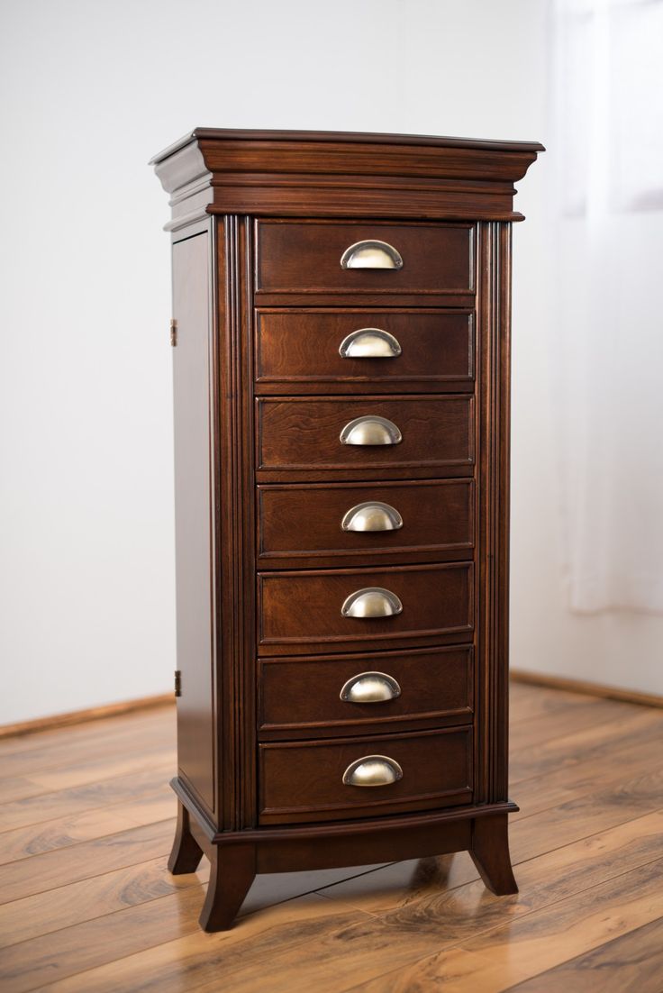 a tall wooden cabinet sitting on top of a hard wood floor