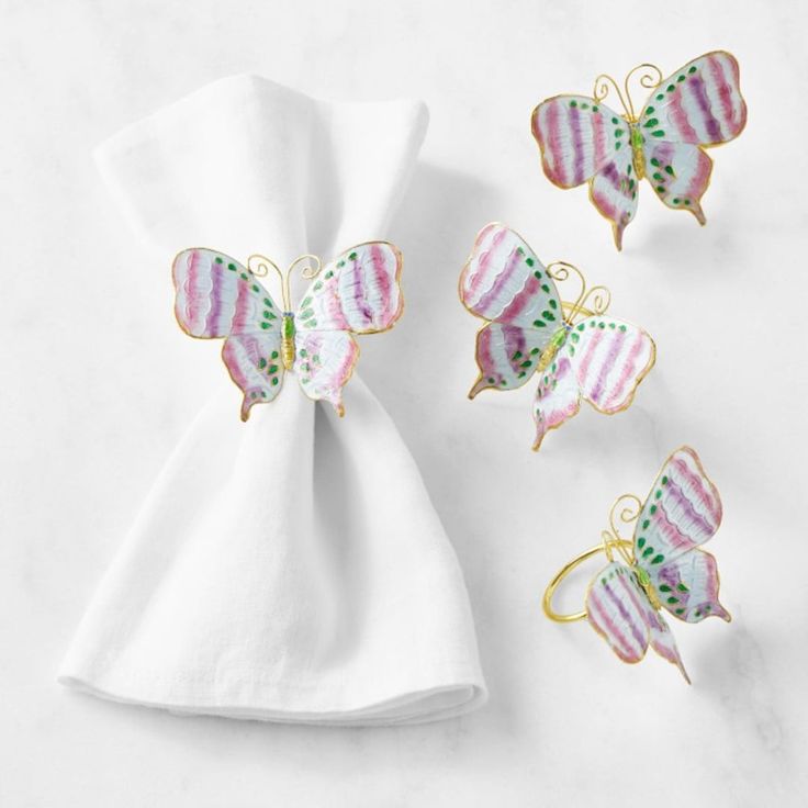 three butterfly napkins and two napkin clips