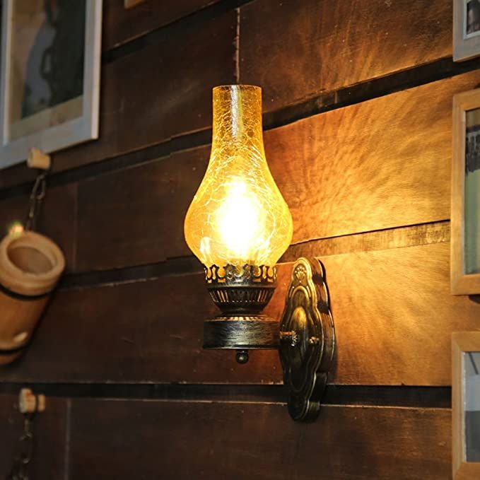 a light that is on the side of a wooden wall next to a lamp fixture