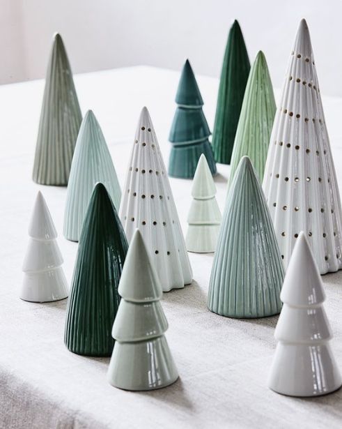 small ceramic christmas trees lined up on a table