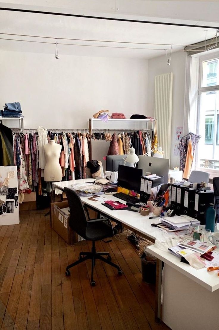 a room filled with lots of clothes and desks