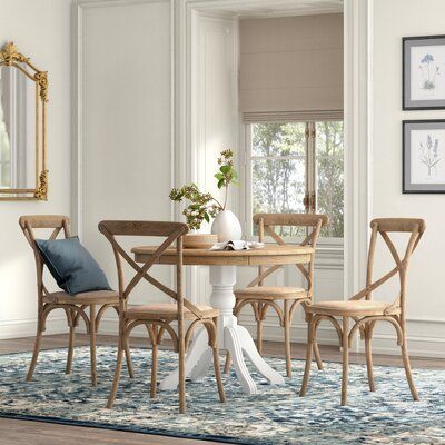 a dining room table with chairs and a rug