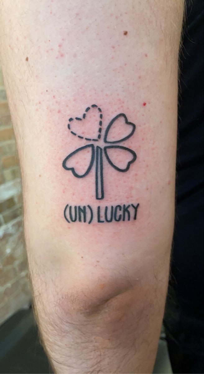 a man with a tattoo on his leg that says, and lucky in black ink