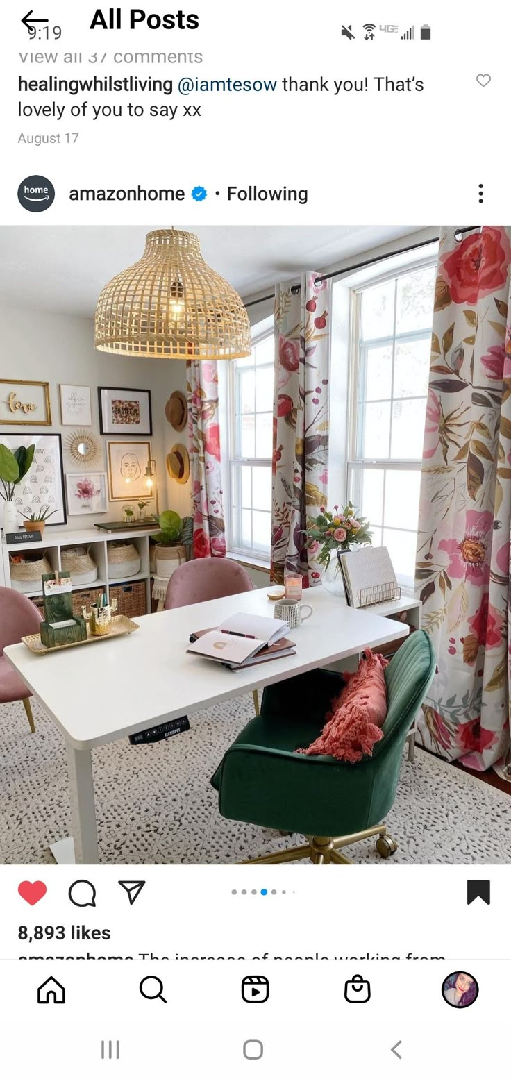 an instagramted photo of a living room with pink and green chairs, a white table, and a gold chandelier