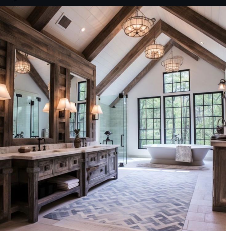 a large bathroom with double sinks and wooden beams on the ceiling, along with two tubs