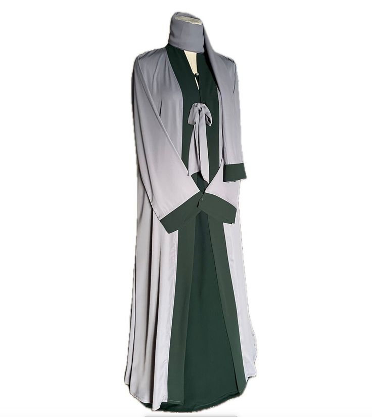 Light gray and green abaya burqa 3-piece set with matching hijab/scarf in high quality fabric, summer friendly, and suitable for all weather conditions.  Abaya upper kaftan/cape and hijab is handmade in soft, lightweight, breathable abaya fabric bordered with rich green georgette fabric matching under abaya.  Under green abaya is handmade in super soft cotton linen fabric, full sleeved with zippered side pockets and pearl neck button.  Abaya cape and under abaya are detachable, may be worn together or separately, as per choice.  Available in size 54. Modest Green Abaya For Eid, Green Long Sleeve Niqab For Eid, Green Niqab For Eid, Modest Long Green Abaya, Layer Abaya, Abaya Cape, Green Abaya, Abaya Fabric, Pearl Neck