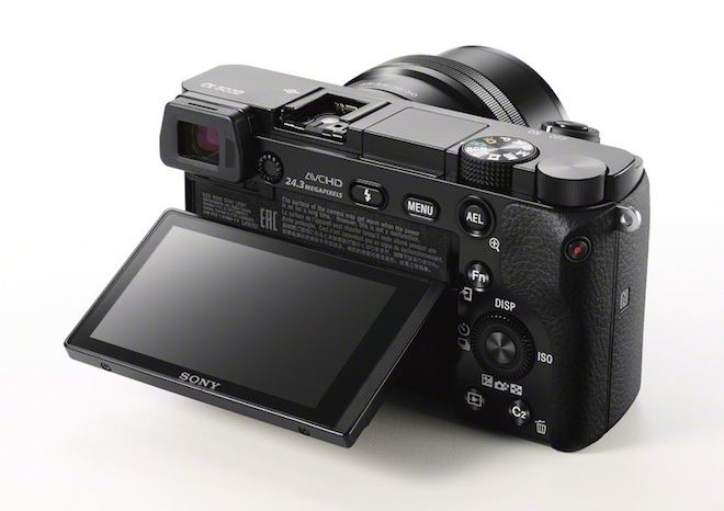 a digital camera sitting on top of a white table next to a tablet pc computer