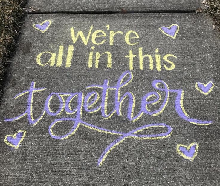 we're all in this together written on the sidewalk with chalk and crayons