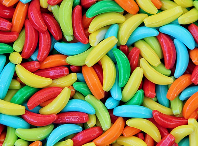 many different colored candy beans are scattered together