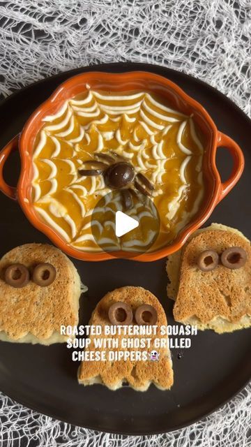 toasted butternut squash soup with ghost grilled cheese dippers on a black plate