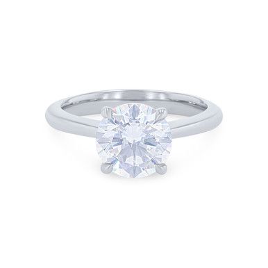 a round brilliant cut diamond engagement ring in 18k white gold, set with a tapered band