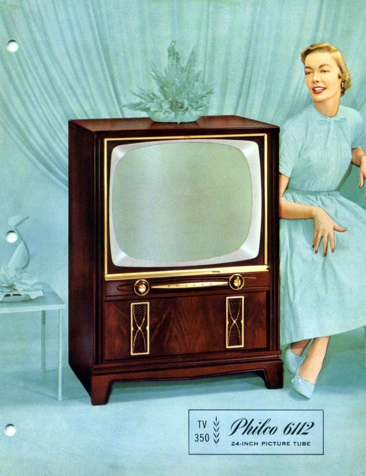 a woman leaning on an old fashioned television