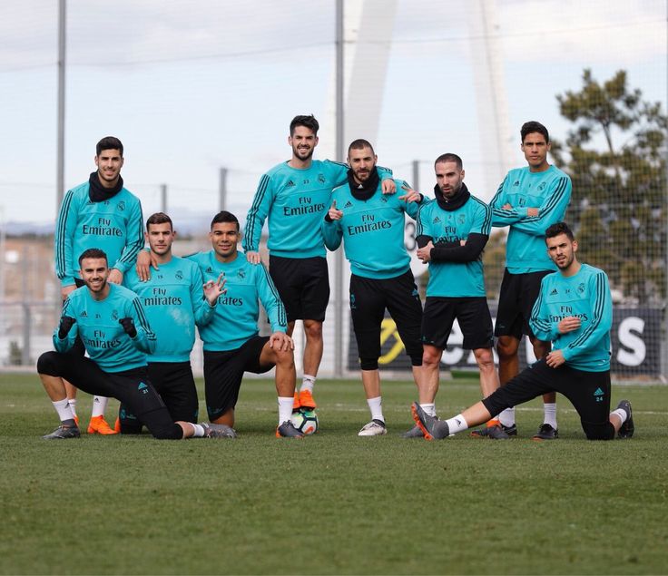 the soccer team is posing for a group photo on the field in their blue uniforms