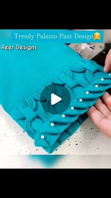 someone is cutting out a piece of fabric with scissors