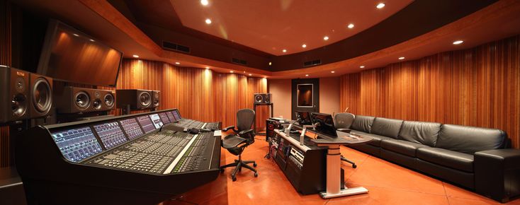 a recording studio with couches and sound equipment