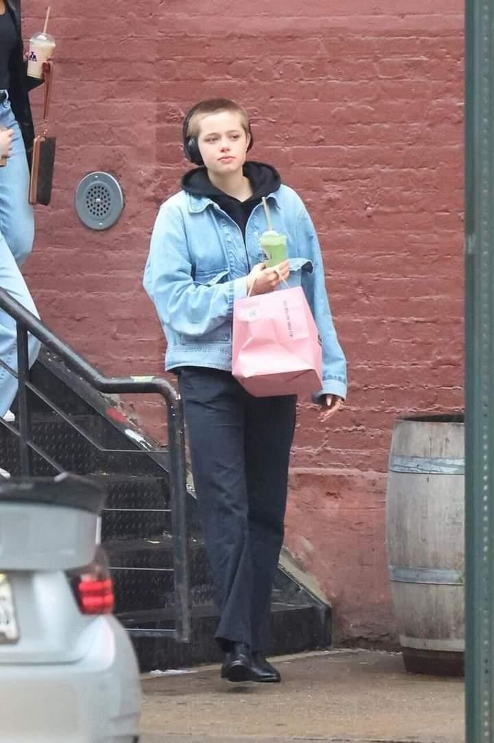 a woman walking down the street carrying shopping bags