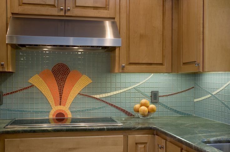 a kitchen with wooden cabinets and glass tile backsplashes on the counter top