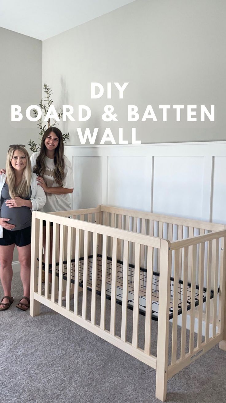 two women standing next to a baby crib with the words diy board and batten wall