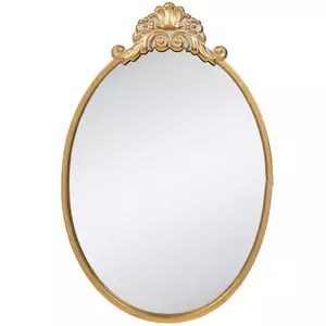 an oval gold mirror with ornate detailing