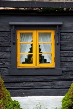 a black and white house with yellow windows