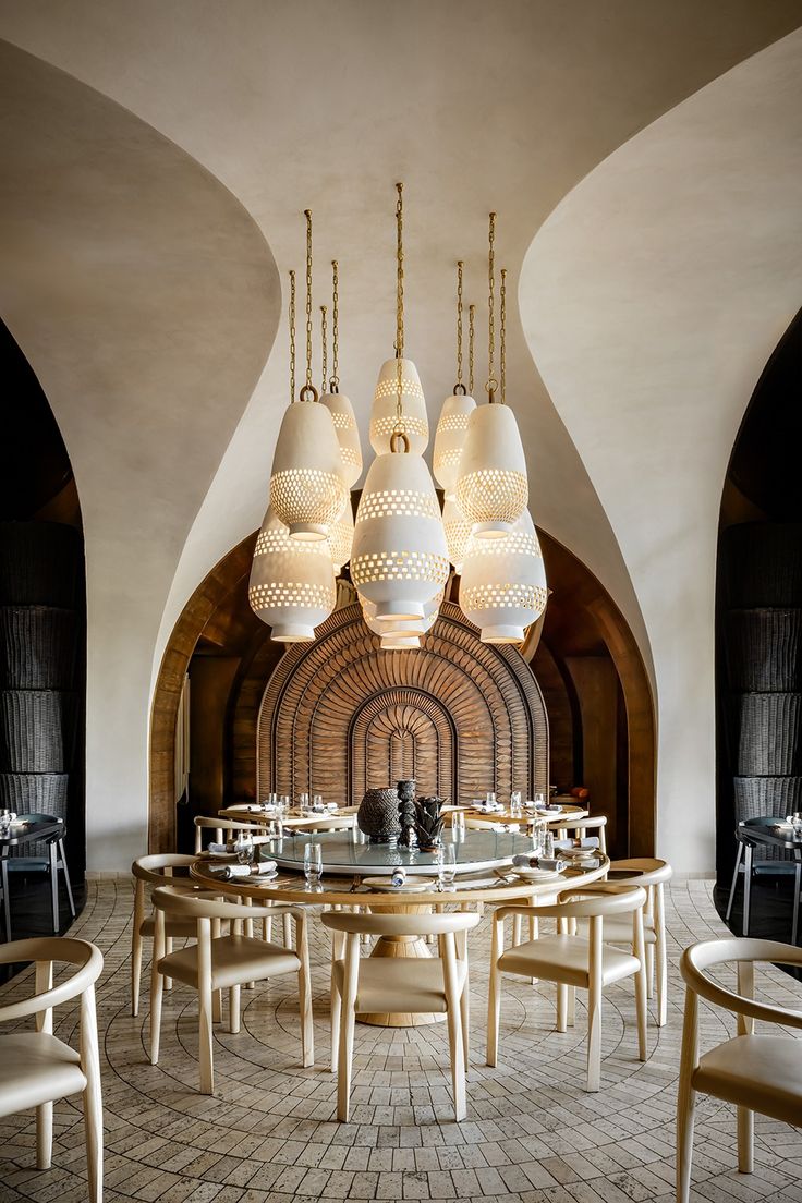 a restaurant with round tables and white chairs