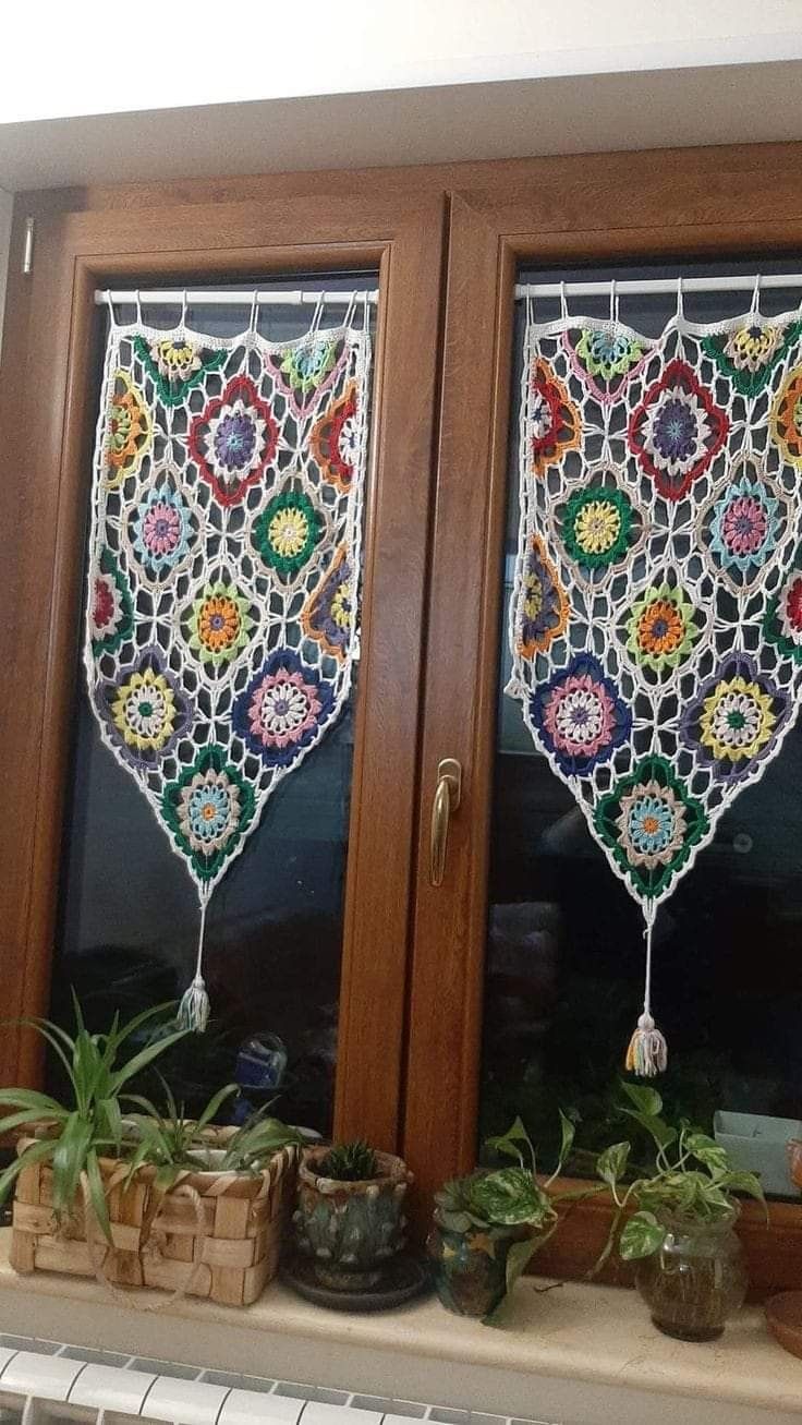 two stained glass windows with potted plants in them