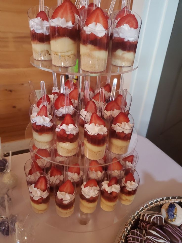 several desserts are arranged in cups on a table