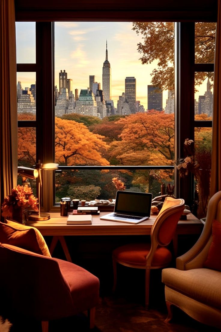 a desk with a laptop on it in front of a large window overlooking the city