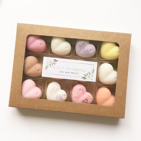 an open box of heart shaped soaps on a white surface with a label that says melt's so simple