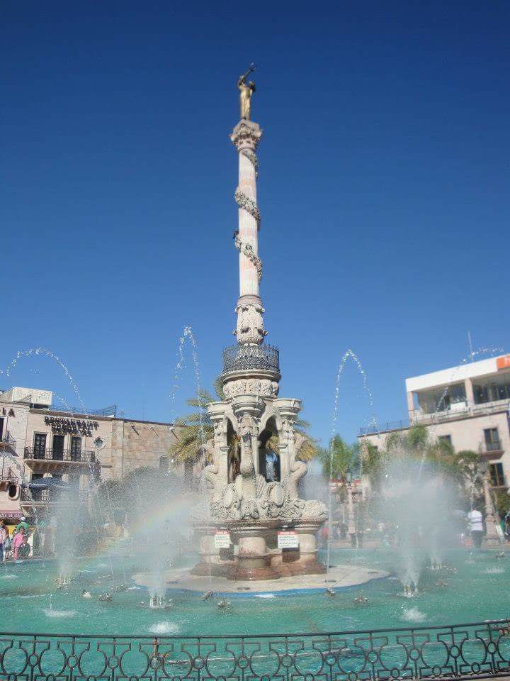 a fountain in the middle of a city square