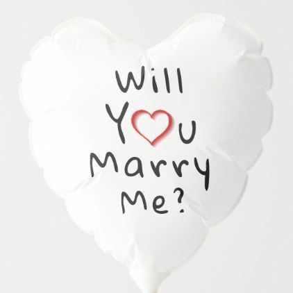 a white heart shaped balloon with the words will you marry me? written on it