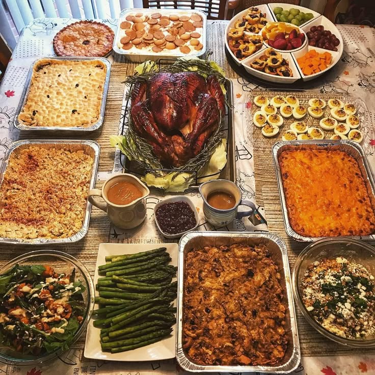 a table full of food including turkey, green beans, and other foods on it