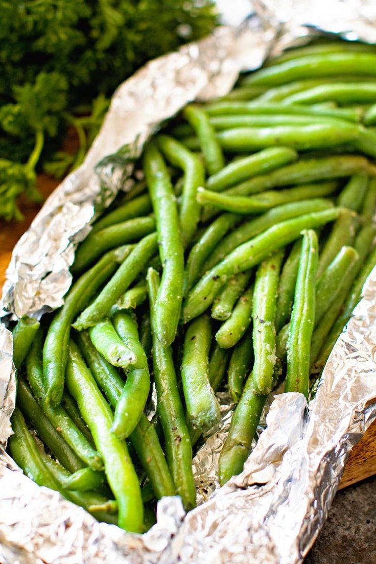 some green beans and broccoli in tin foil