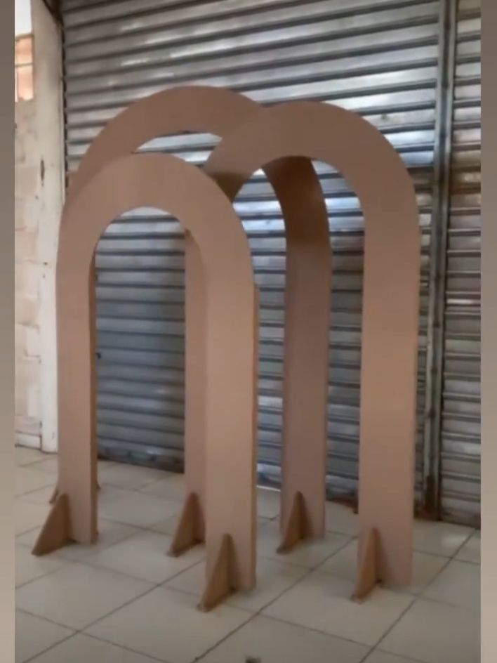 two large pink arches sitting on top of a tile floor next to a roller door