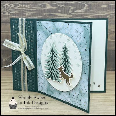 a handmade christmas card with a deer and pine trees